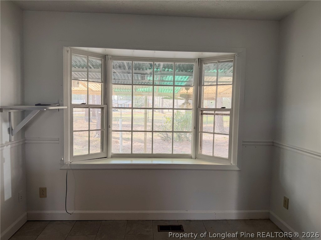 575 Veterans Road St. Pauls, NC 28384 - Photo 7 of 27 a view of an empty room with a window