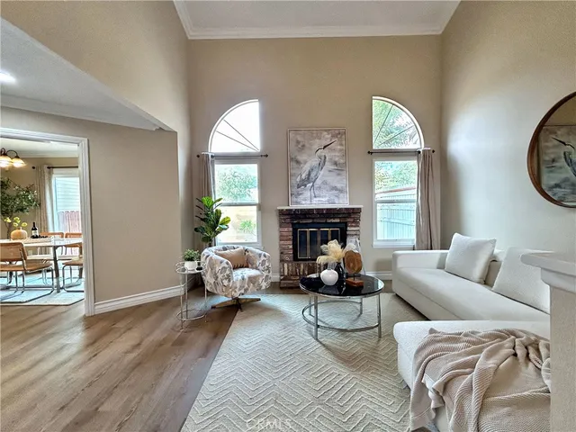 a living room with furniture two window and a fireplace