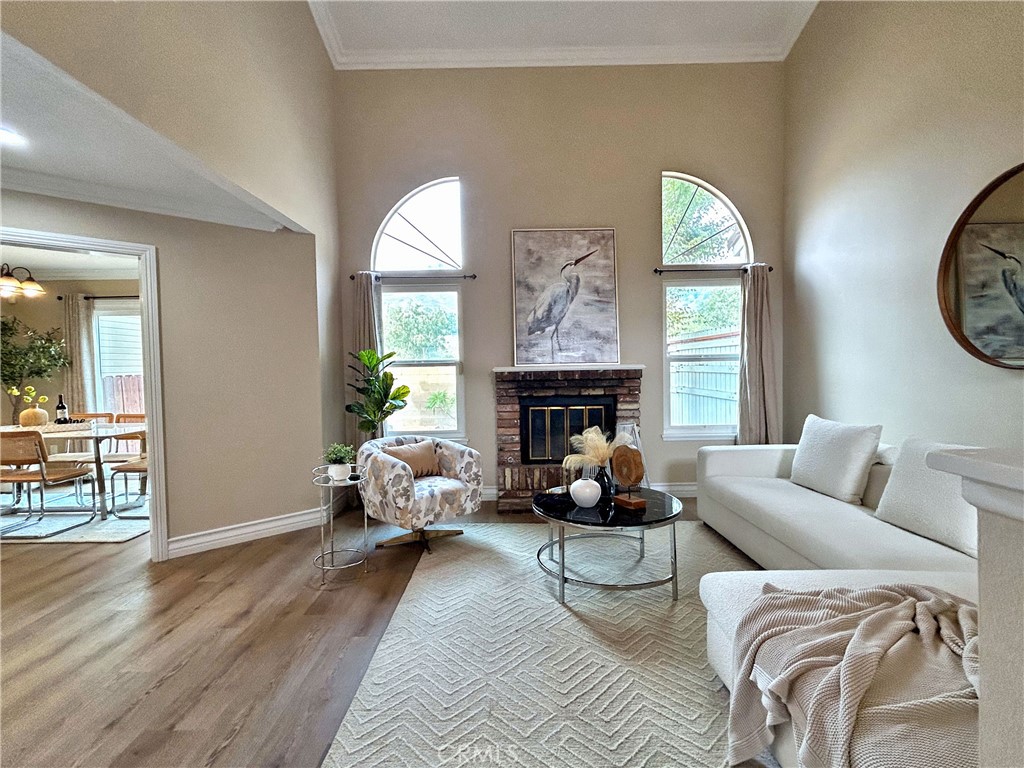 555 Canyon Hill Road San Dimas, CA 91773 - Photo 11 of 16 a living room with furniture two window and a fireplace
