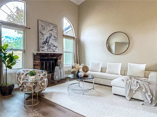 a living room with furniture a fireplace and a large mirror