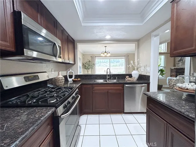 a kitchen with a stove a sink and a microwave