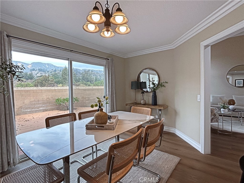 555 Canyon Hill Road San Dimas, CA 91773 - Photo 7 of 16 a view of a dining room with furniture a chandelier and wooden floor