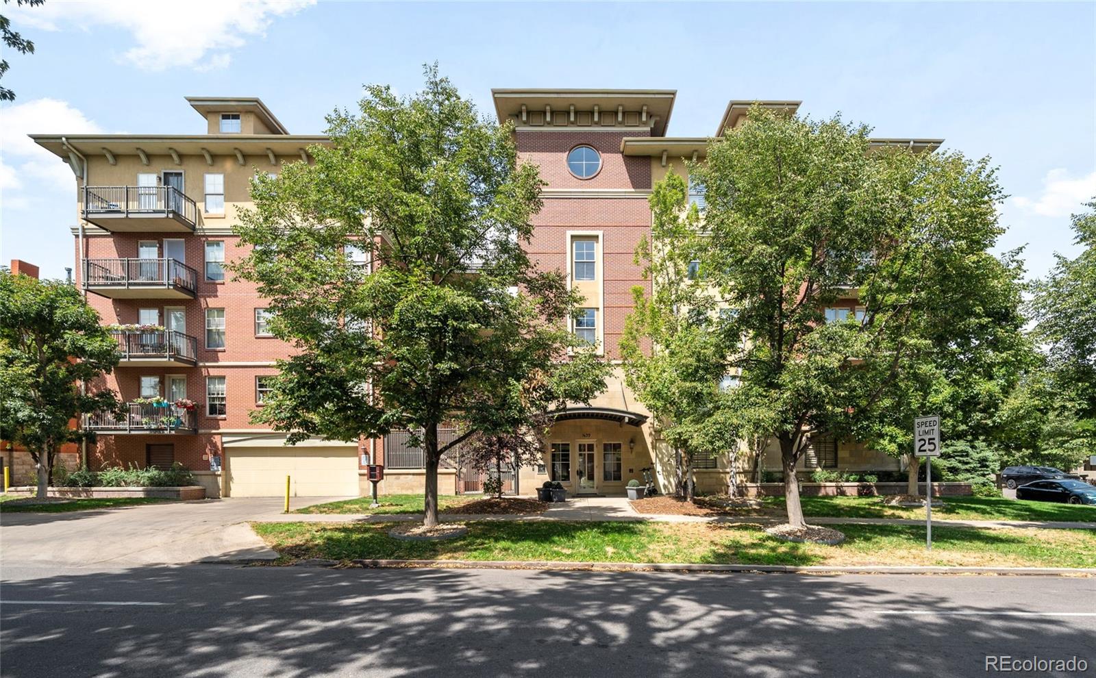 a front view of a building with trees