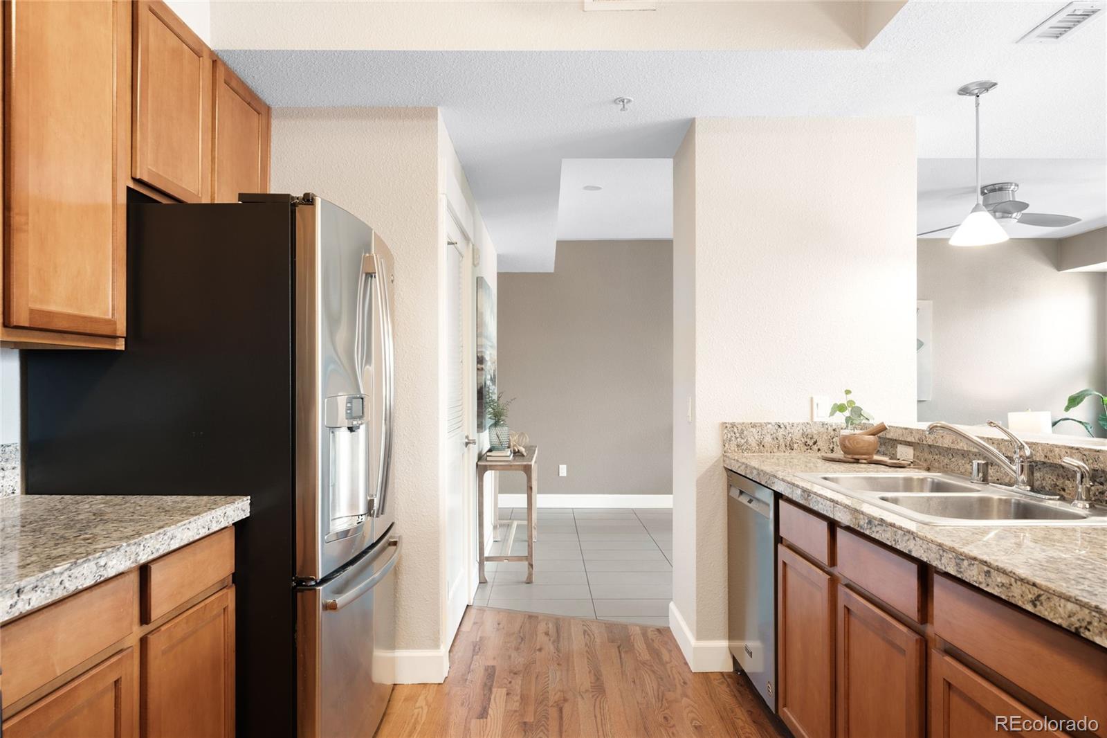 1699 North Downing Street, Unit 306 Denver, CO 80218 - Photo 13 of 26 a bathroom with a granite countertop sink a mirror and shower