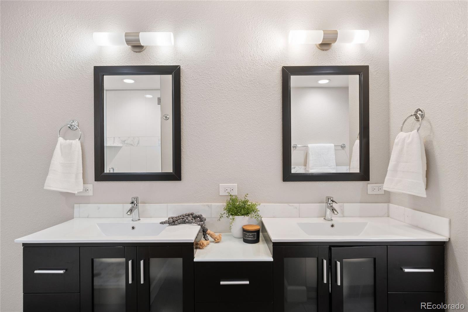 1699 North Downing Street, Unit 306 Denver, CO 80218 - Photo 19 of 26 a bathroom with a sink and a mirror