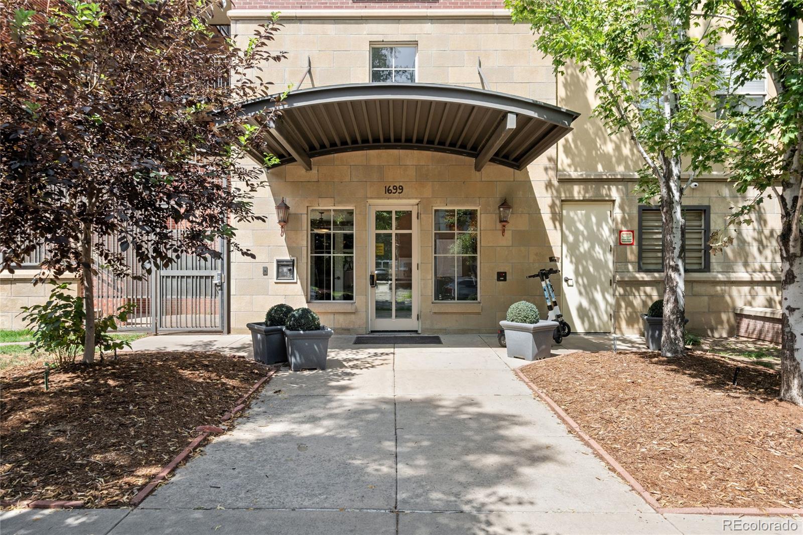 1699 North Downing Street, Unit 306 Denver, CO 80218 - Photo 2 of 26 a front view of a house with outdoor space