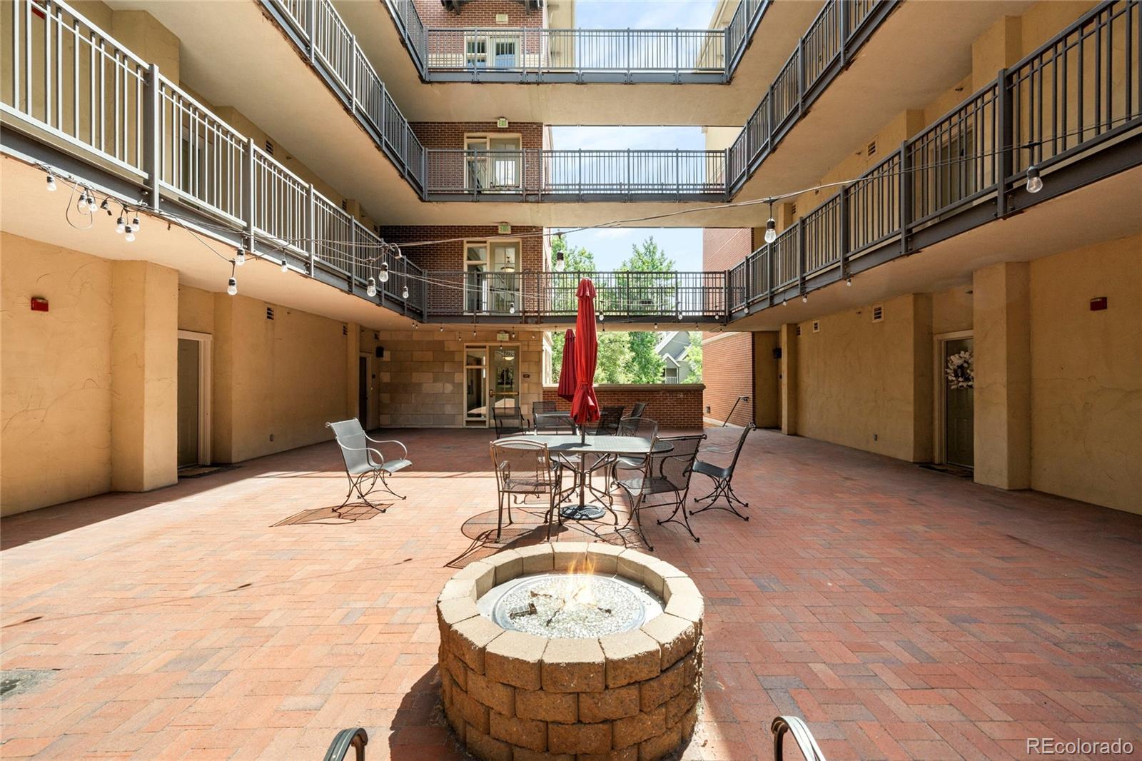1699 North Downing Street, Unit 306 Denver, CO 80218 - Photo 25 of 26 a view of a patio with a table and chairs