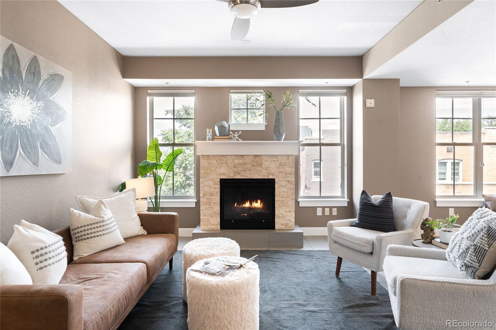 1699 North Downing Street, Unit 306 Denver, CO 80218 - Photo 3 of 26 a living room with furniture and a fireplace