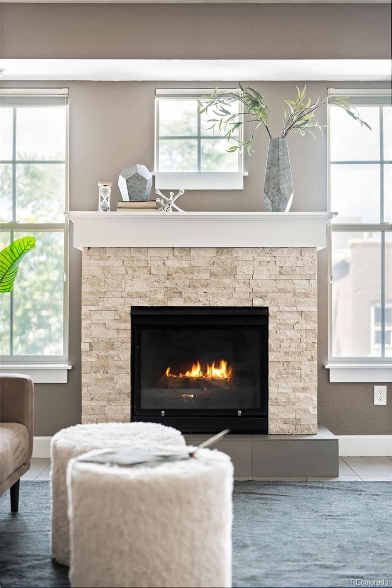 1699 North Downing Street, Unit 306 Denver, CO 80218 - Photo 6 of 26 a living room with a fireplace and a large window