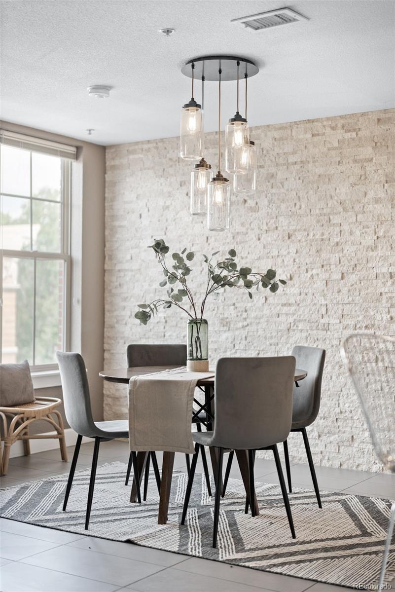 1699 North Downing Street, Unit 306 Denver, CO 80218 - Photo 8 of 26 a view of a dining room with furniture a chandelier and wooden floor