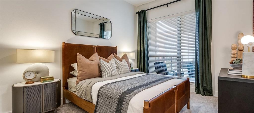 650 East Sycamore Street, Unit 1151 Denton, TX 76205 - Photo 5 of 19 a bedroom with a bed and lamp