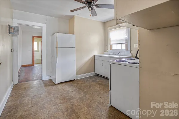 a view of a kitchen with a stove cabinets and a refrigerator
