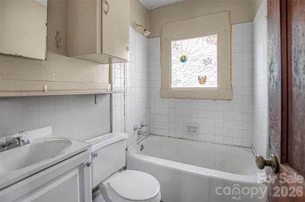 a bathroom with a sink a toilet and bathtub
