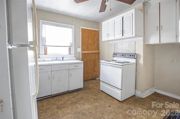 a utility room with cabinets washer and dryer