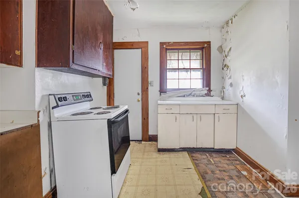 a kitchen with a stove and a white cabinets