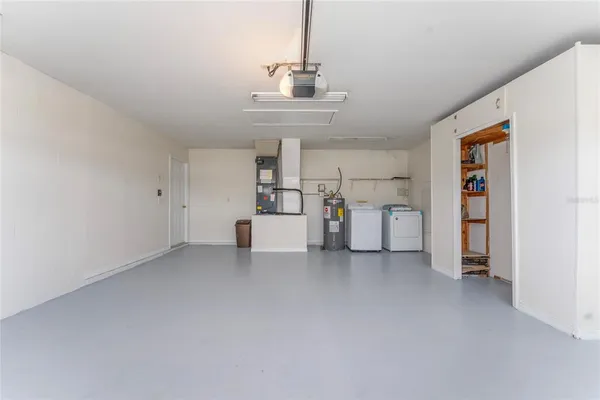a view of a kitchen with furniture and white walls