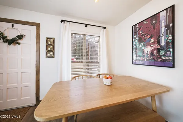 a view of a dining room with a table and chairs