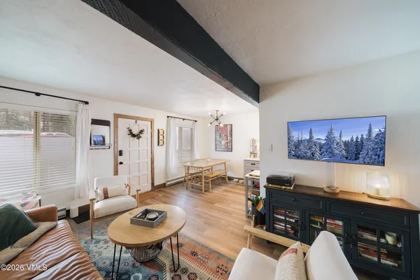 a living room with furniture and a flat screen tv