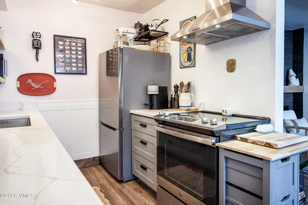 a stove top oven sitting inside of a kitchen