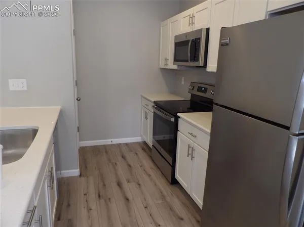 a kitchen with a stove microwave and sink