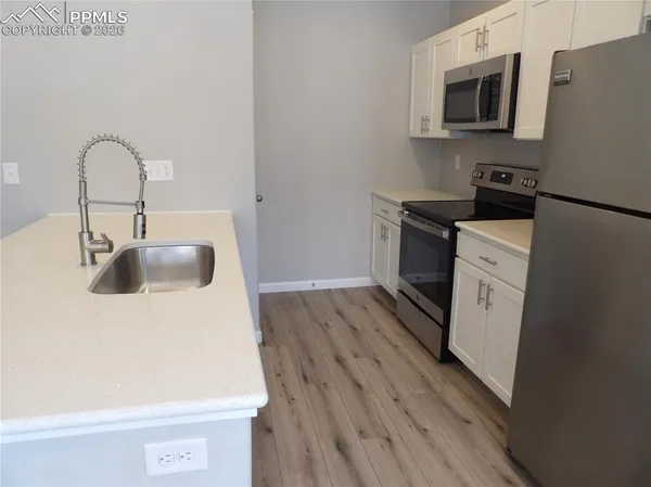 a kitchen with a sink and a stove top oven