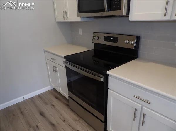 a stove top oven sitting inside of a kitchen