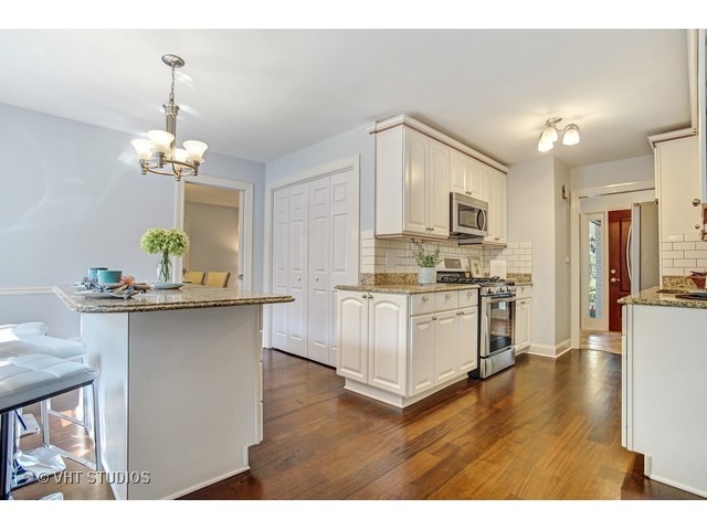 3720 Wilke Road Rolling Meadows, IL 60008 - Photo 11 of 25 a kitchen with kitchen island white cabinets and stainless steel appliances