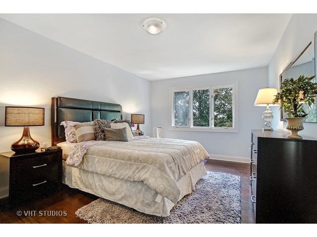 3720 Wilke Road Rolling Meadows, IL 60008 - Photo 12 of 25 a bedroom with a bed and a potted plant