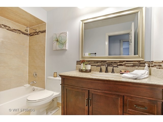 3720 Wilke Road Rolling Meadows, IL 60008 - Photo 13 of 25 a bathroom with a sink a toilet and shower