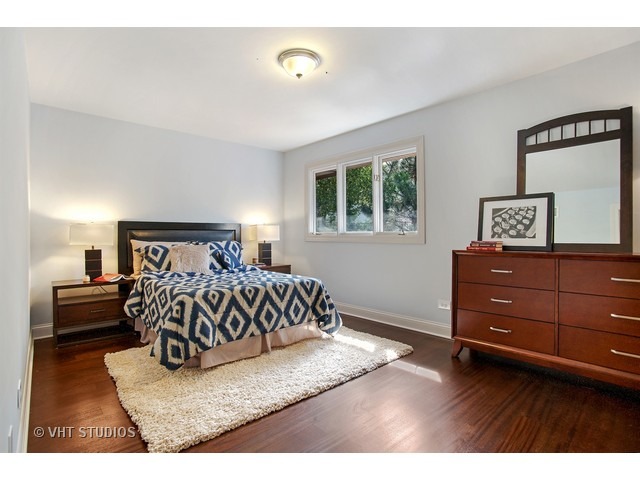 3720 Wilke Road Rolling Meadows, IL 60008 - Photo 15 of 25 a bedroom with a bed and a night stand