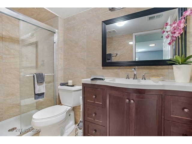 3720 Wilke Road Rolling Meadows, IL 60008 - Photo 16 of 25 a bathroom with a sink vanity mirror and toilet
