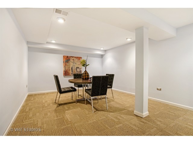3720 Wilke Road Rolling Meadows, IL 60008 - Photo 20 of 25 a view of a dining room with furniture and a rug