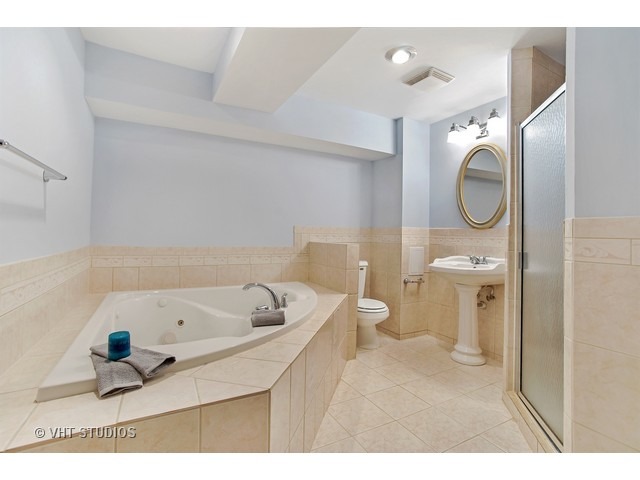3720 Wilke Road Rolling Meadows, IL 60008 - Photo 21 of 25 a bathroom with a sink a toilet and a mirror
