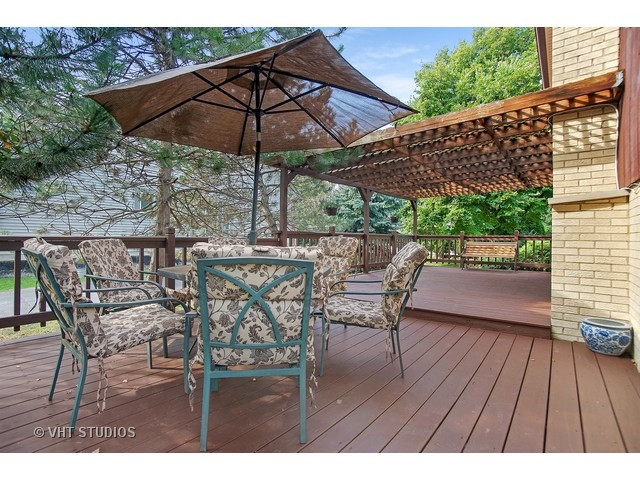 3720 Wilke Road Rolling Meadows, IL 60008 - Photo 24 of 25 a patio with wooden floor a yard a table and chairs