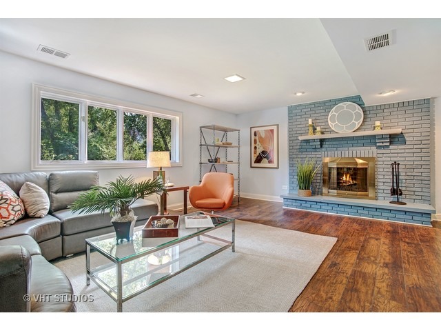 3720 Wilke Road Rolling Meadows, IL 60008 - Photo 5 of 25 a living room with furniture a window and a fireplace