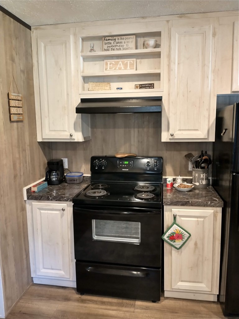 2438 Ridge Road Pigeon Forge, TN 37863 - Photo 12 of 37 a stove top oven sitting inside of a kitchen