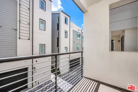 a view of a balcony with wooden floor