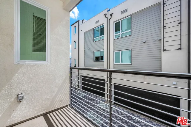 a view of a balcony with window and stairs