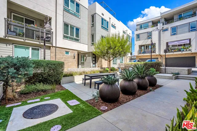 a view of a patio with couches chairs and potted plants