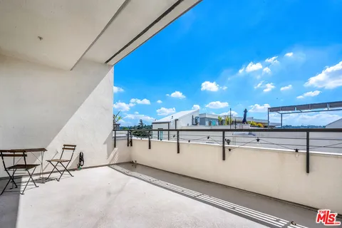 a view of a house with a yard and potted plants