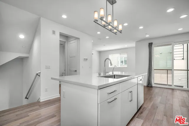 a bathroom with a sink a large mirror and vanity