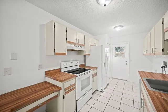 a kitchen with a stove and a refrigerator