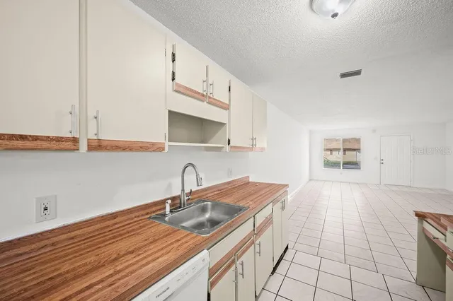 a kitchen with a sink and cabinets