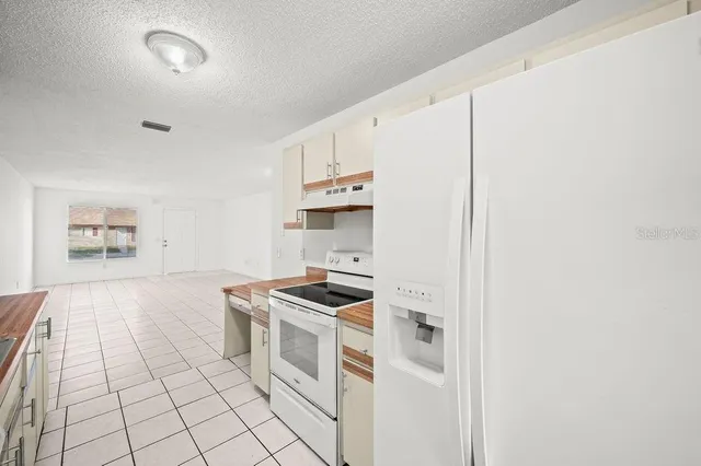 a kitchen with a stove cabinets and a refrigerator