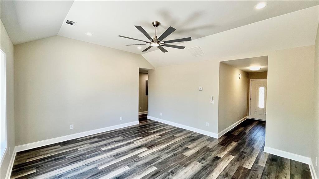 5 Green Road Griffin, GA 30224 - Photo 13 of 34 a view of a big room with wooden floor and a ceiling fan