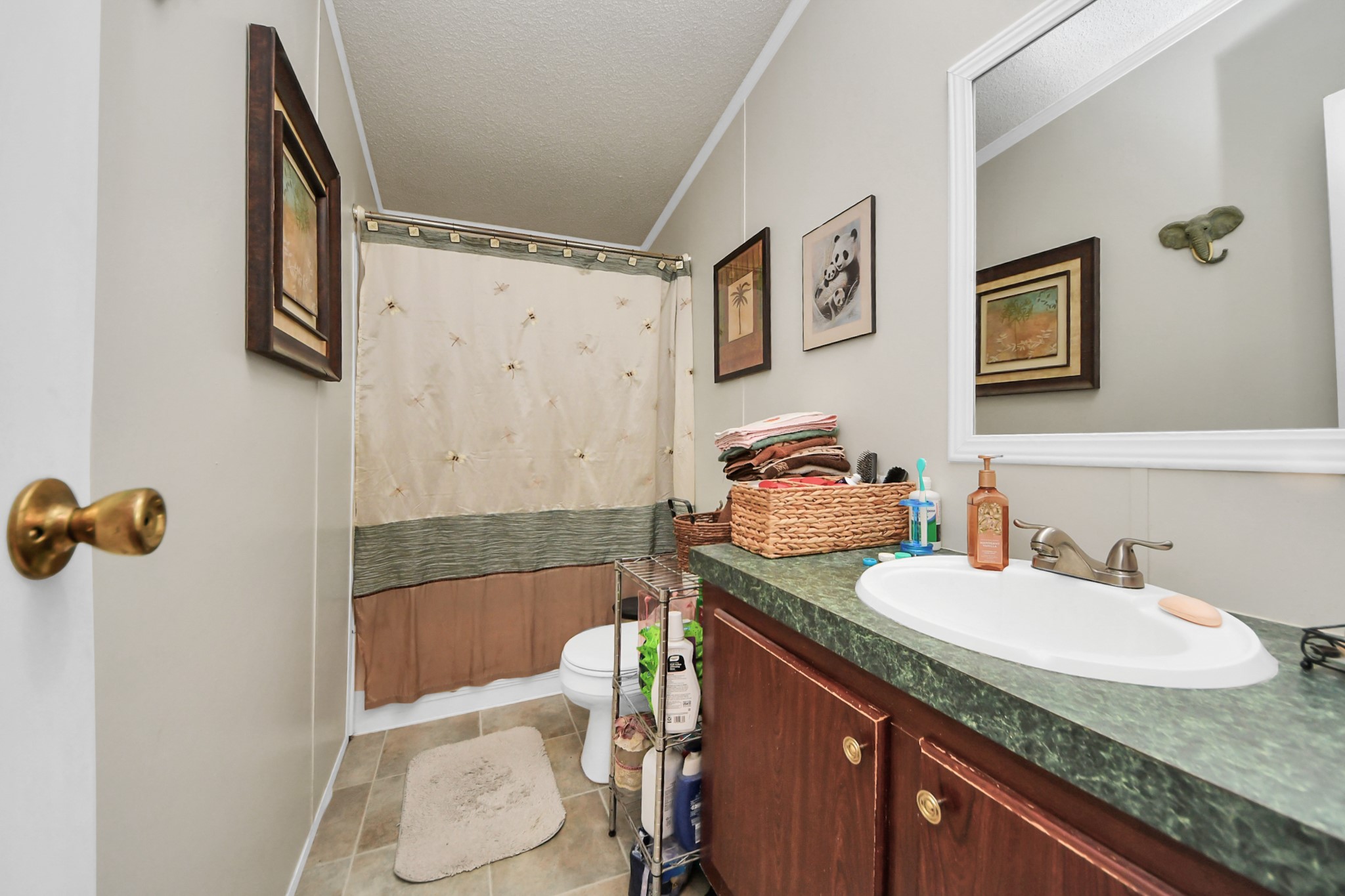 204 Edith Street Highlands, TX 77562 - Photo 17 of 33 a bathroom with a granite countertop sink and a mirror