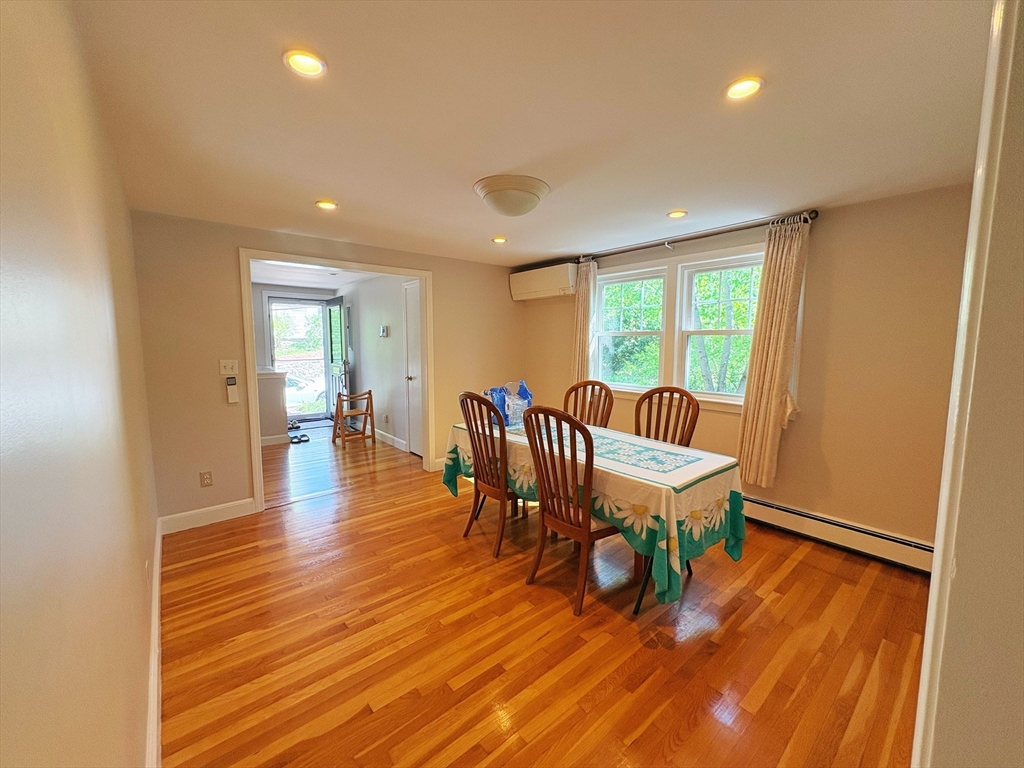 55 Sutherland Road, Unit 55 Arlington, MA 02476 - Photo 7 of 23 a dining room with furniture and wooden floor