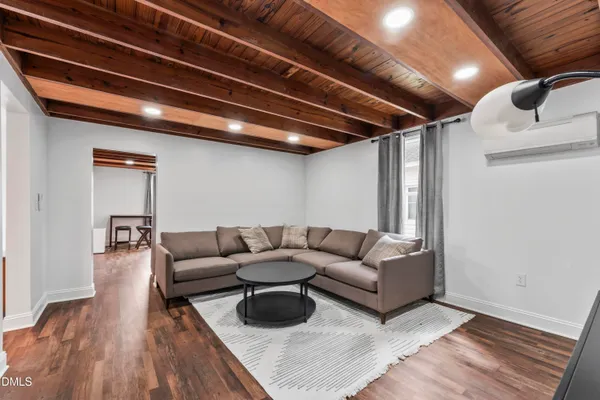 a living room with furniture and wooden floor