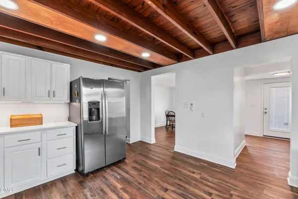 a view of a kitchen with wooden floors and cabinet