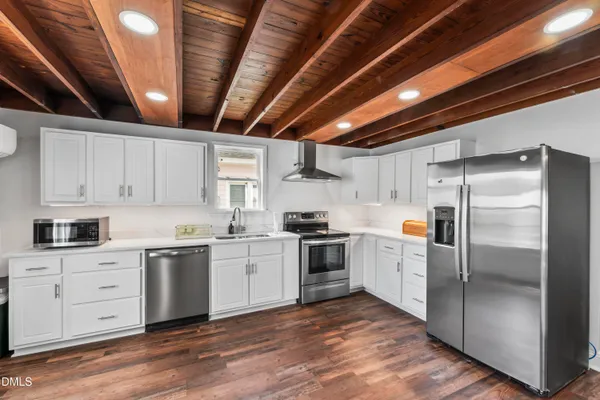 a kitchen with a sink stainless steel appliances and cabinets
